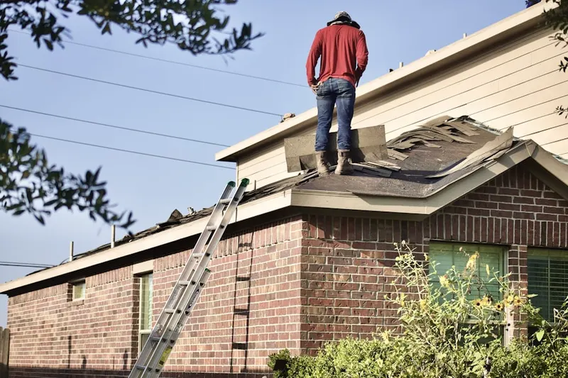 Professional roofer working on a residential roof in Gibbon